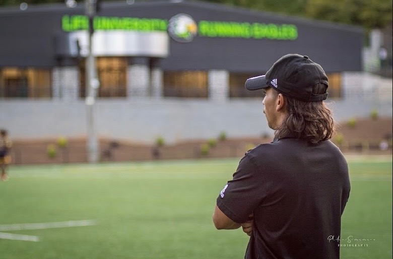 Adrian on the sideline at the Life University rugby field
