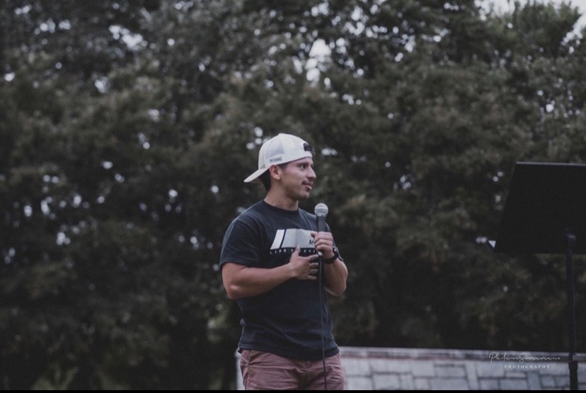 Adrian speaking to a community gathering